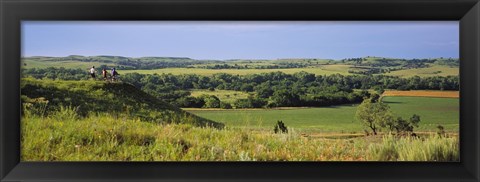 Framed Three mountain bikers on a hill, Kansas, USA Print