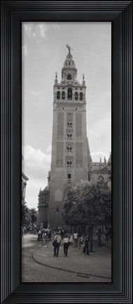 Framed Group of people walking near a church, La Giralda, Seville Cathedral, Seville, Seville Province, Andalusia, Spain Print