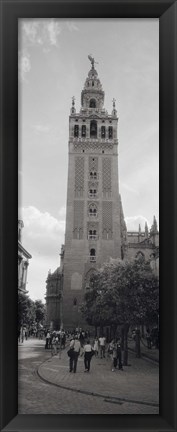 Framed Group of people walking near a church, La Giralda, Seville Cathedral, Seville, Seville Province, Andalusia, Spain Print