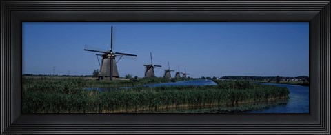 Framed Traditional windmills at a riverbank, Kinderdijk, Rotterdam, Netherlands Print