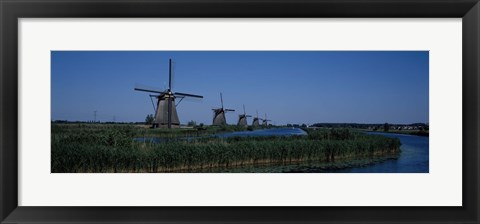 Framed Traditional windmills at a riverbank, Kinderdijk, Rotterdam, Netherlands Print