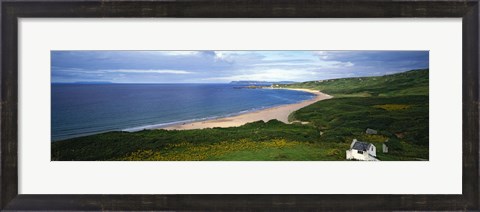 Framed Birds-eye view of sea, white stone cottage, Northern Ireland. Print