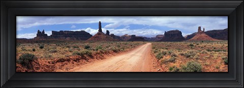 Framed Dirt road through desert landscape with sandstone formations, Utah. Print