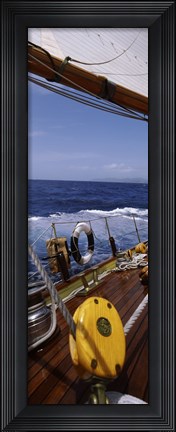 Framed Detail of the mainsheet block of a wooden sailboat in the sea Print