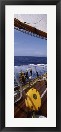 Framed Detail of the mainsheet block of a wooden sailboat in the sea Print