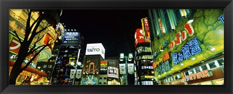 Framed Low angle view of buildings lit up at night, Shinjuku Ward, Tokyo Prefecture, Kanto Region, Japan Print