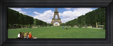 Framed Tourists sitting in a park with a tower in the background, Eiffel Tower, Paris, Ile-de-France, France Print