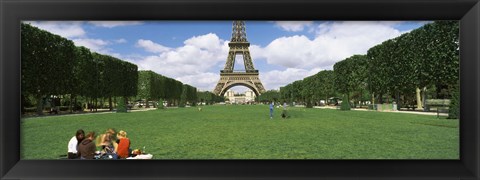 Framed Tourists sitting in a park with a tower in the background, Eiffel Tower, Paris, Ile-de-France, France Print