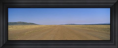 Framed Dirt road passing through a landscape, Masai Mara National Reserve, Great Rift Valley, Kenya Print