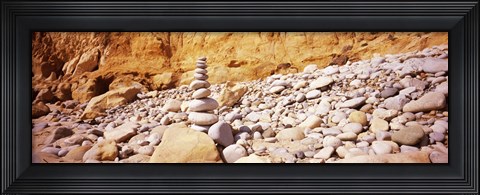 Framed Stack of stones on the beach, California, USA Print