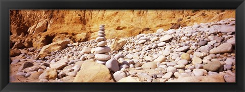 Framed Stack of stones on the beach, California, USA Print