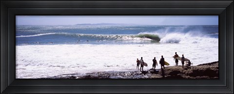 Framed Silhouette of surfers standing on the beach, Australia Print