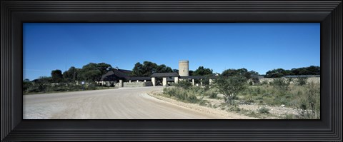 Framed Road leading towards the entrance of a rest camp, Okaukuejo, Etosha National Park, Kunene Region, Namibia Print