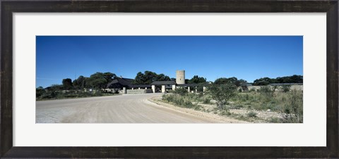 Framed Road leading towards the entrance of a rest camp, Okaukuejo, Etosha National Park, Kunene Region, Namibia Print