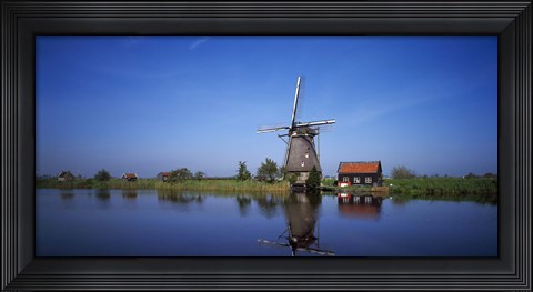Framed Reflection of a traditional windmill in a lake, Netherlands Print