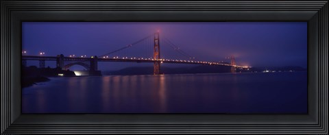 Framed Suspension bridge lit up at dawn viewed from fishing pier, Golden Gate Bridge, San Francisco Bay, San Francisco, California, USA Print