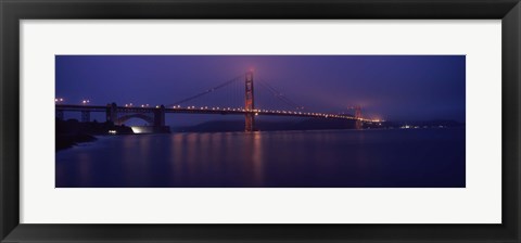 Framed Suspension bridge lit up at dawn viewed from fishing pier, Golden Gate Bridge, San Francisco Bay, San Francisco, California, USA Print