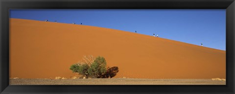 Framed Tourists climbing up a sand dune, Dune 45, Sossusvlei, Namib Desert, Namibia Print