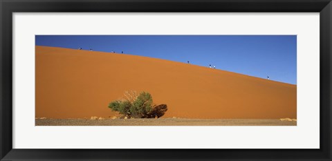 Framed Tourists climbing up a sand dune, Dune 45, Sossusvlei, Namib Desert, Namibia Print