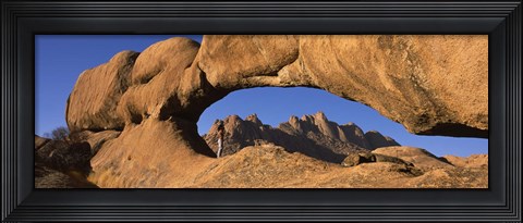 Framed Mountains viewed through a natural arch with a mother holding her baby, Spitzkoppe, Namib Desert, Namibia Print