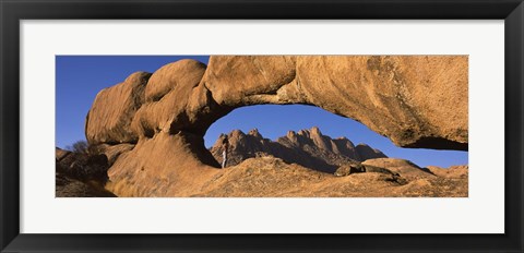 Framed Mountains viewed through a natural arch with a mother holding her baby, Spitzkoppe, Namib Desert, Namibia Print