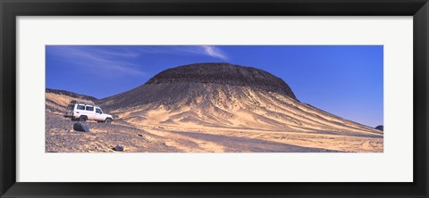 Framed SUV moving in a desert, Black Desert, Bahariya Oasis, Egypt Print