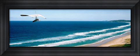 Framed Hang glider over the sea Print