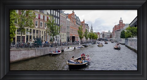 Framed Tourboats in a canal, Amsterdam, Netherlands Print
