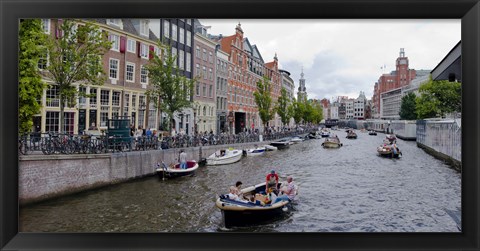 Framed Tourboats in a canal, Amsterdam, Netherlands Print