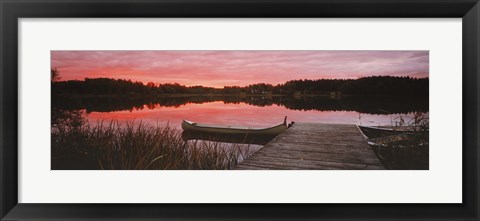 Framed Canoe tied to dock on a small lake at sunset, Sweden Print