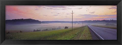 Framed Country road and telephone lines splitting farmlands at dawn, Finland Print