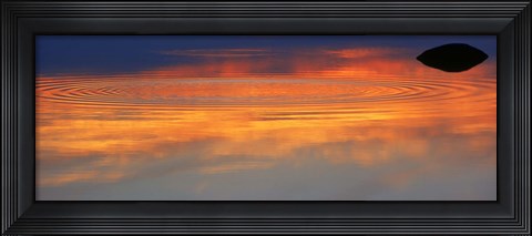 Framed Reflection of clouds with circular ripples spreading outward across glassy lake waters at sunset Print
