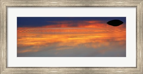 Framed Reflection of clouds with circular ripples spreading outward across glassy lake waters at sunset Print