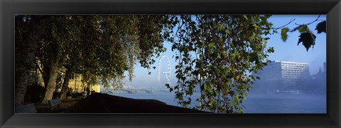 Framed Ferris wheel looking viewed through trees, Millennium Wheel, Thames River, South Bank, London, England Print