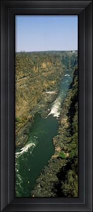 Framed Kayakers paddle down the Zambezi gorge away from the Victoria Falls, Zambia Print