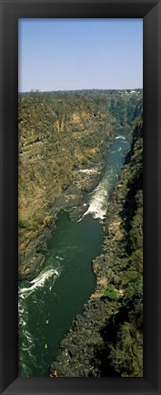 Framed Kayakers paddle down the Zambezi gorge away from the Victoria Falls, Zambia Print