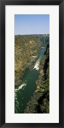 Framed Kayakers paddle down the Zambezi gorge away from the Victoria Falls, Zambia Print