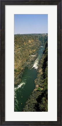 Framed Kayakers paddle down the Zambezi gorge away from the Victoria Falls, Zambia Print
