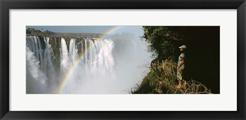 Framed Woman looking at a rainbow over the Victoria Falls, Zimbabwe Print