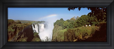 Framed Tourists at a viewing point looking at the rainbow formed over Victoria Falls, Zimbabwe Print