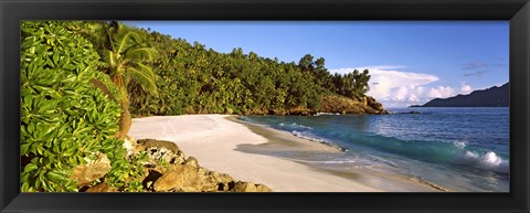 Framed Waves breaking on a small secluded beach on North Island, Seychelles Print