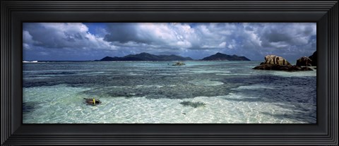 Framed Snorkeler in the clean waters on Anse Source d&#39;Argent beach, La Digue Island, Seychelles Print