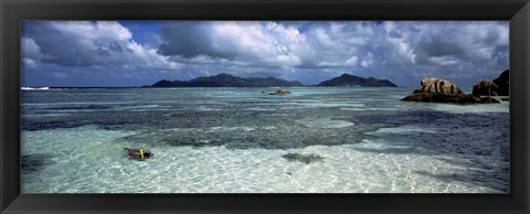 Framed Snorkeler in the clean waters on Anse Source d&#39;Argent beach, La Digue Island, Seychelles Print