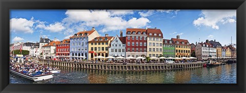 Framed Tourists in a tourboat with buildings along a canal, Nyhavn, Copenhagen, Denmark Print