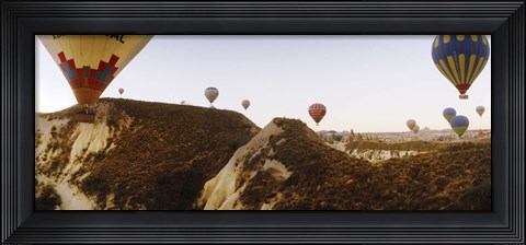 Framed Hot air balloons soaring over a mountain ridge, Cappadocia, Central Anatolia Region, Turkey Print