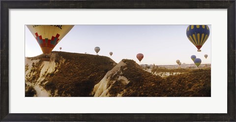 Framed Hot air balloons soaring over a mountain ridge, Cappadocia, Central Anatolia Region, Turkey Print