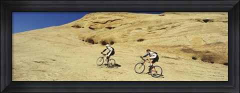Framed Side profile of two men mountain bilking on rocks, Slickrock Trail, Moab, Utah, USA Print