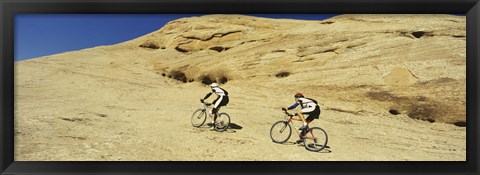 Framed Side profile of two men mountain bilking on rocks, Slickrock Trail, Moab, Utah, USA Print