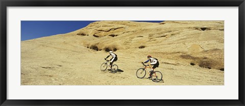 Framed Side profile of two men mountain bilking on rocks, Slickrock Trail, Moab, Utah, USA Print