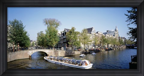Framed Netherlands, Amsterdam, tour boat in channel Print